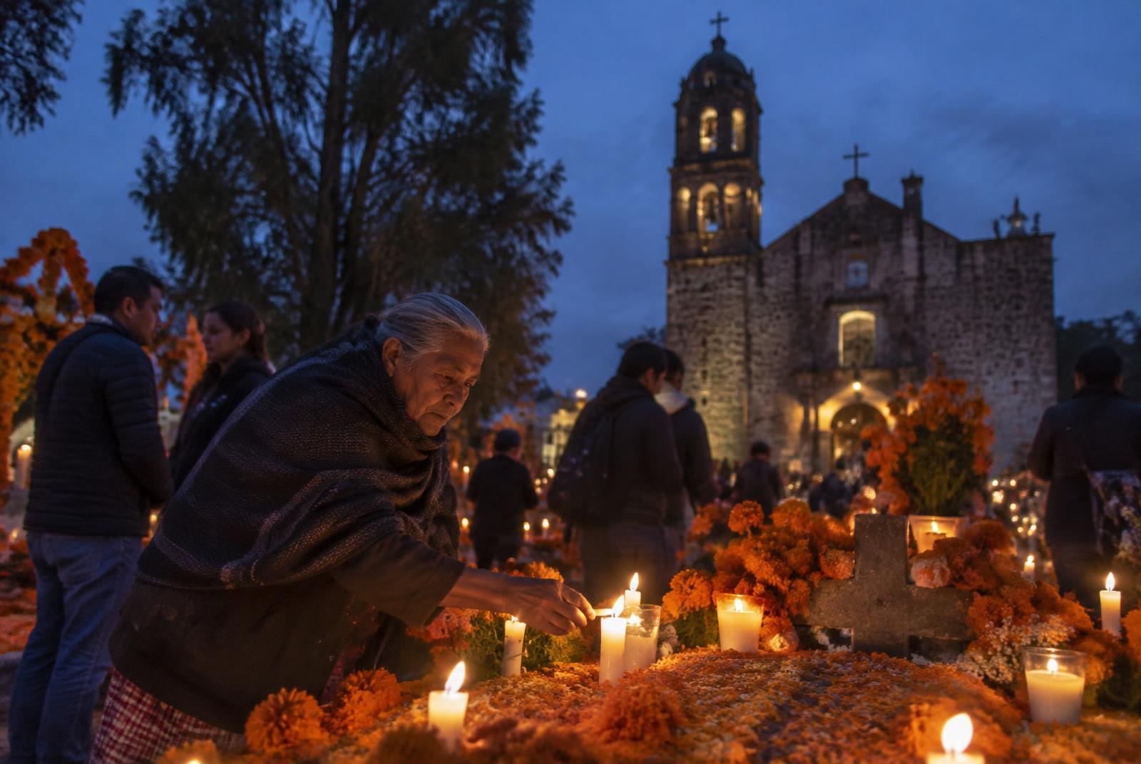 Dusk in San Andrés Mixquic, on the southern edge of Mexico City, as families light the first candles of the alumbrada.